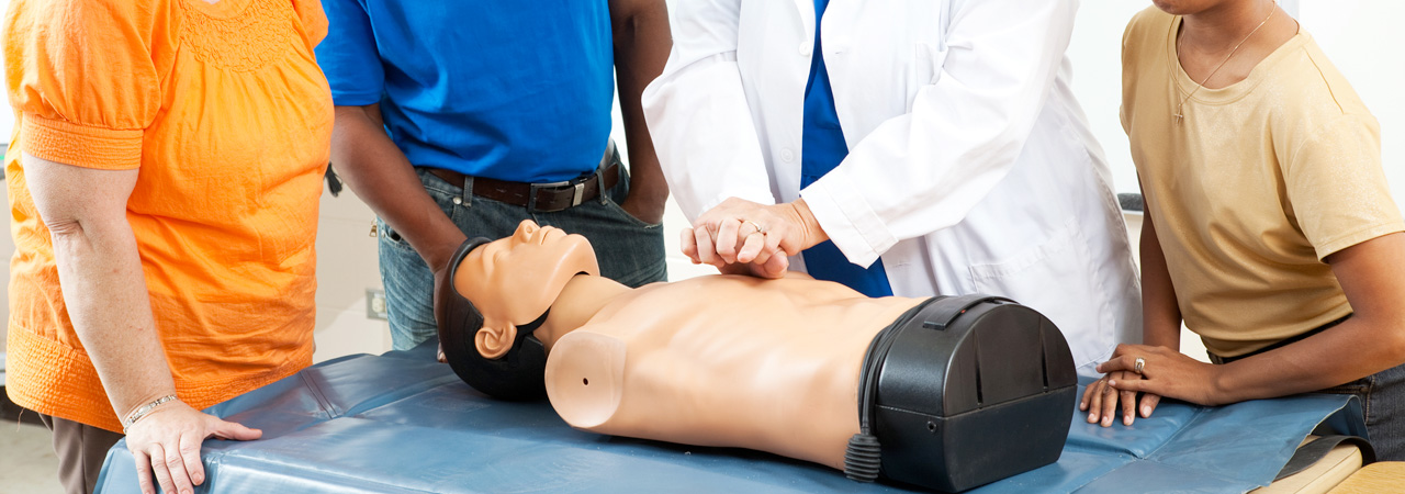 group of people practicing cpr on model