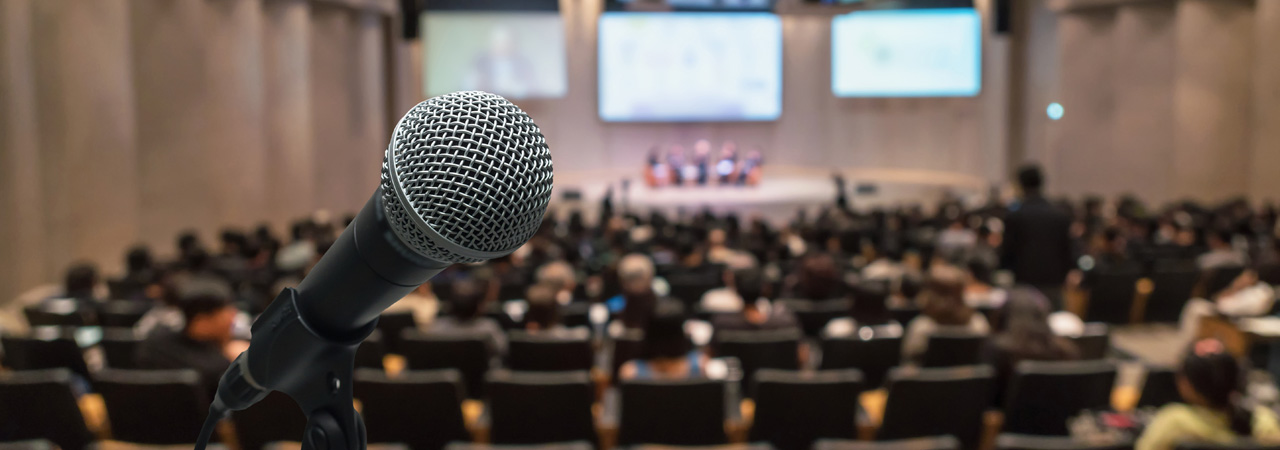 microphone over the abstract blurred photo of conference